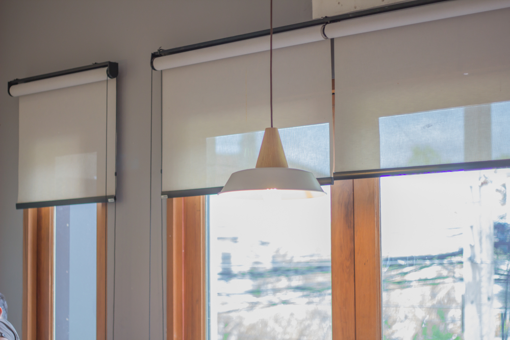 White roller blinds and window.